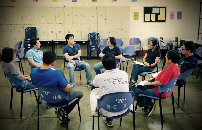 Faculty and Staff members pray and share during the Ateneo HS' Community Spiritual Hour (CSH). In the CSH, we spend an hour every First Friday to reflect on our lives in school. Here, Mr. Franz Santos, Araling Panlipunan subject area coordinator opens his heart to his colleagues. 3 July 2015